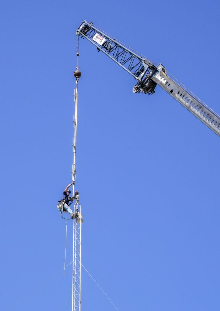 A crane crew from Hightower Communications Inc. mounts new antennas on The Filling Station’s tower in Pollocksville on Sept. 30.